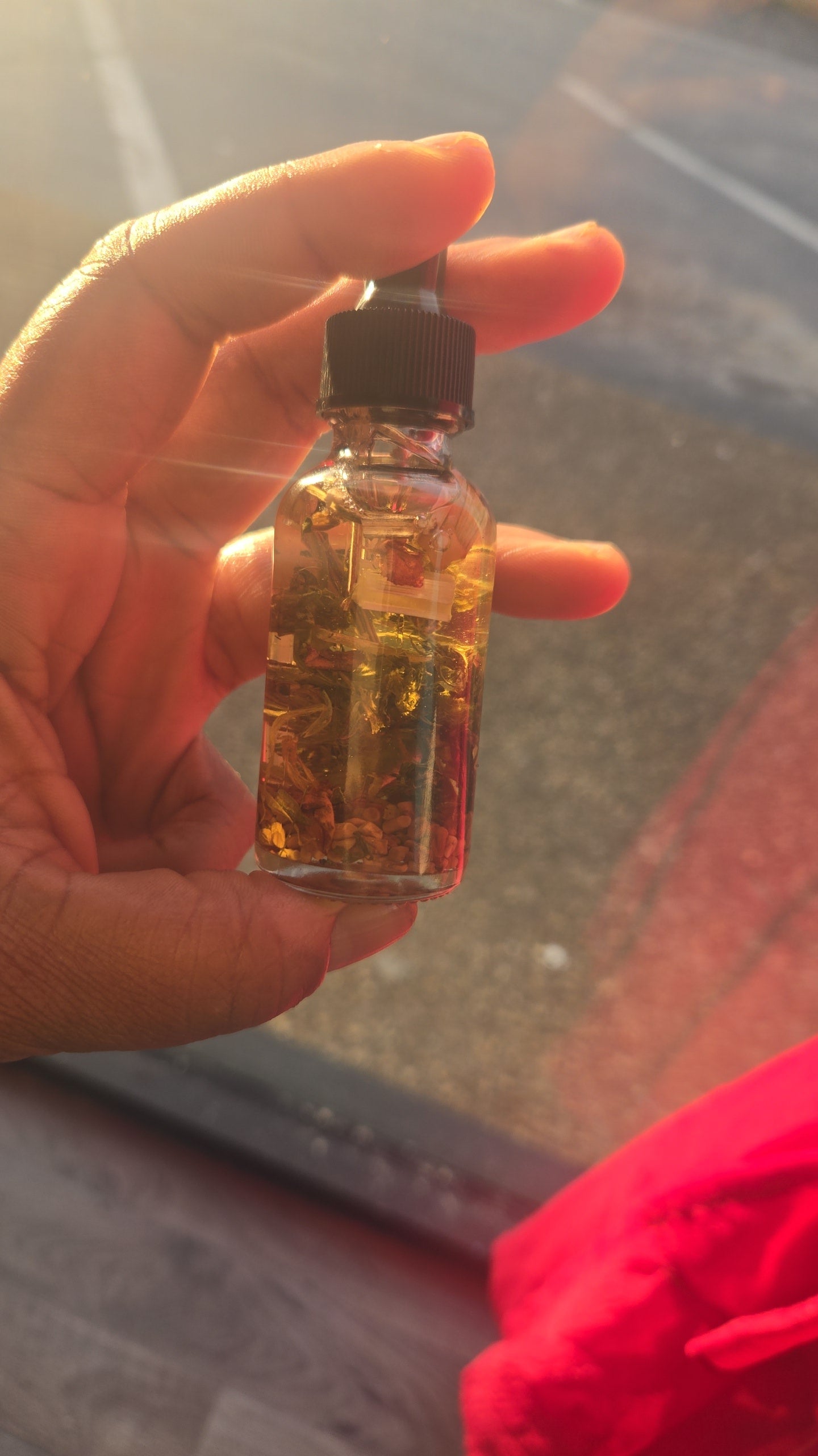 Fertility Conjure Oil bottle with sacred herbs for conception and creative abundance