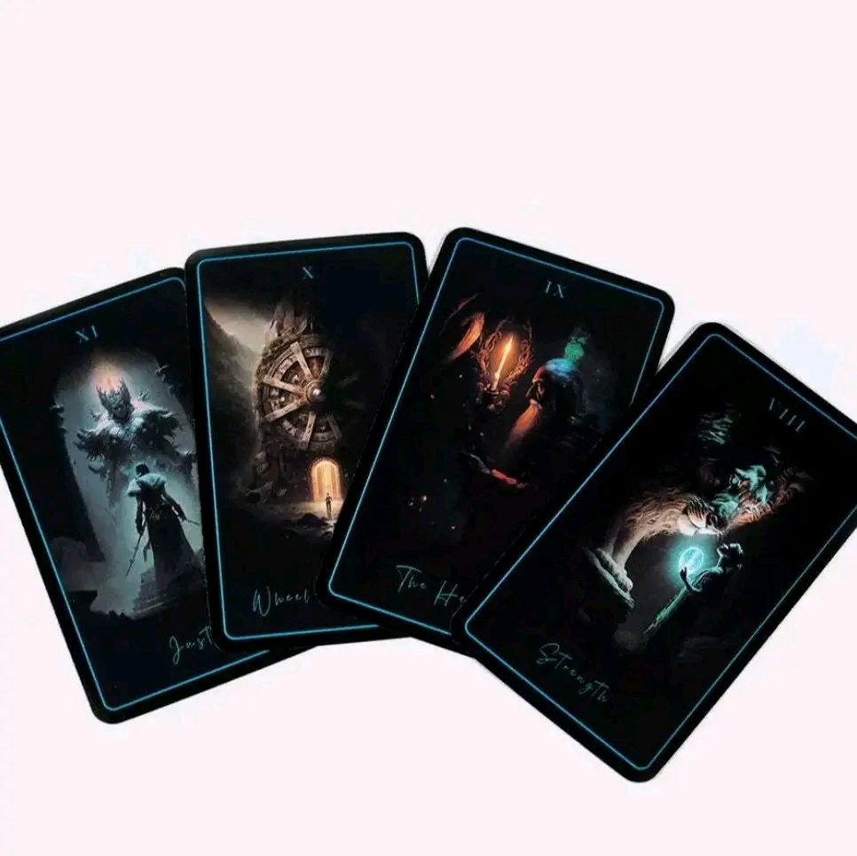 Tarot of Sacred Kingdoms deck showing four dark-themed, intricately illustrated tarot cards with mystical and spiritual imagery