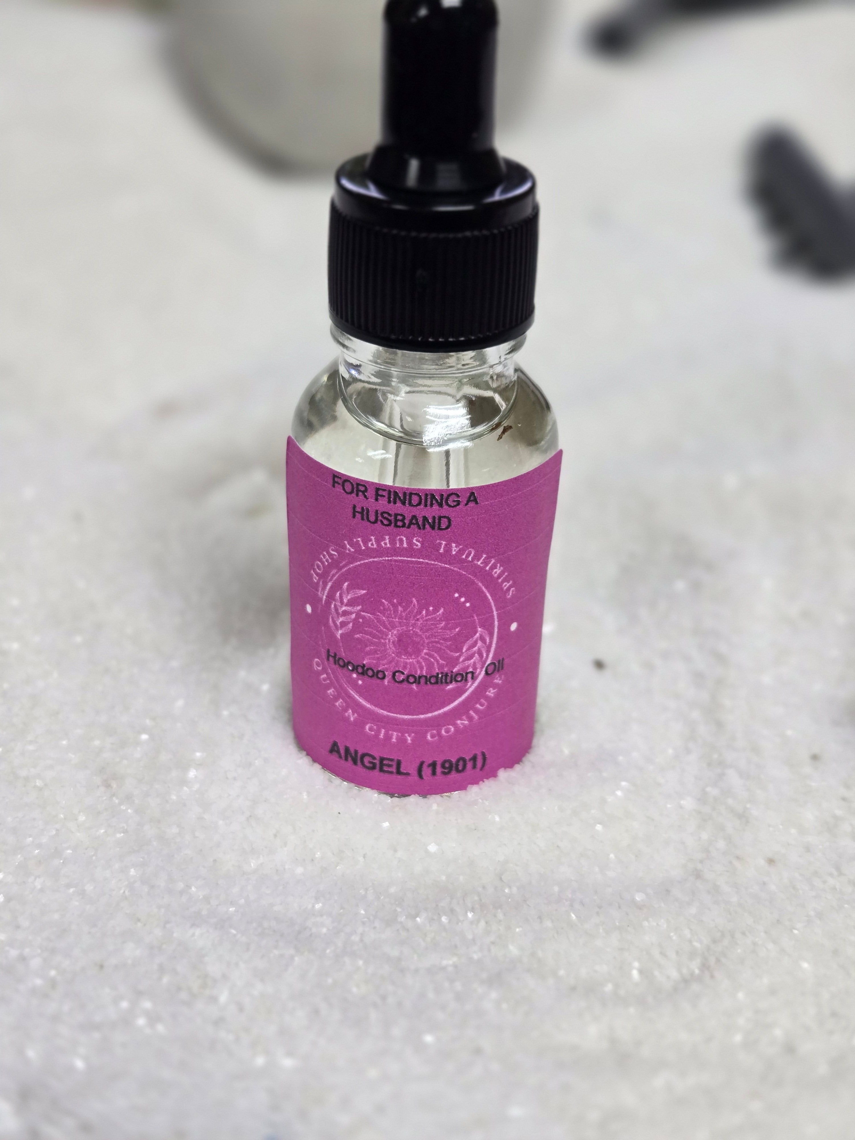 Bottle of 1901 Angel Oil for finding a husband with dropper hoodoo condition on white background