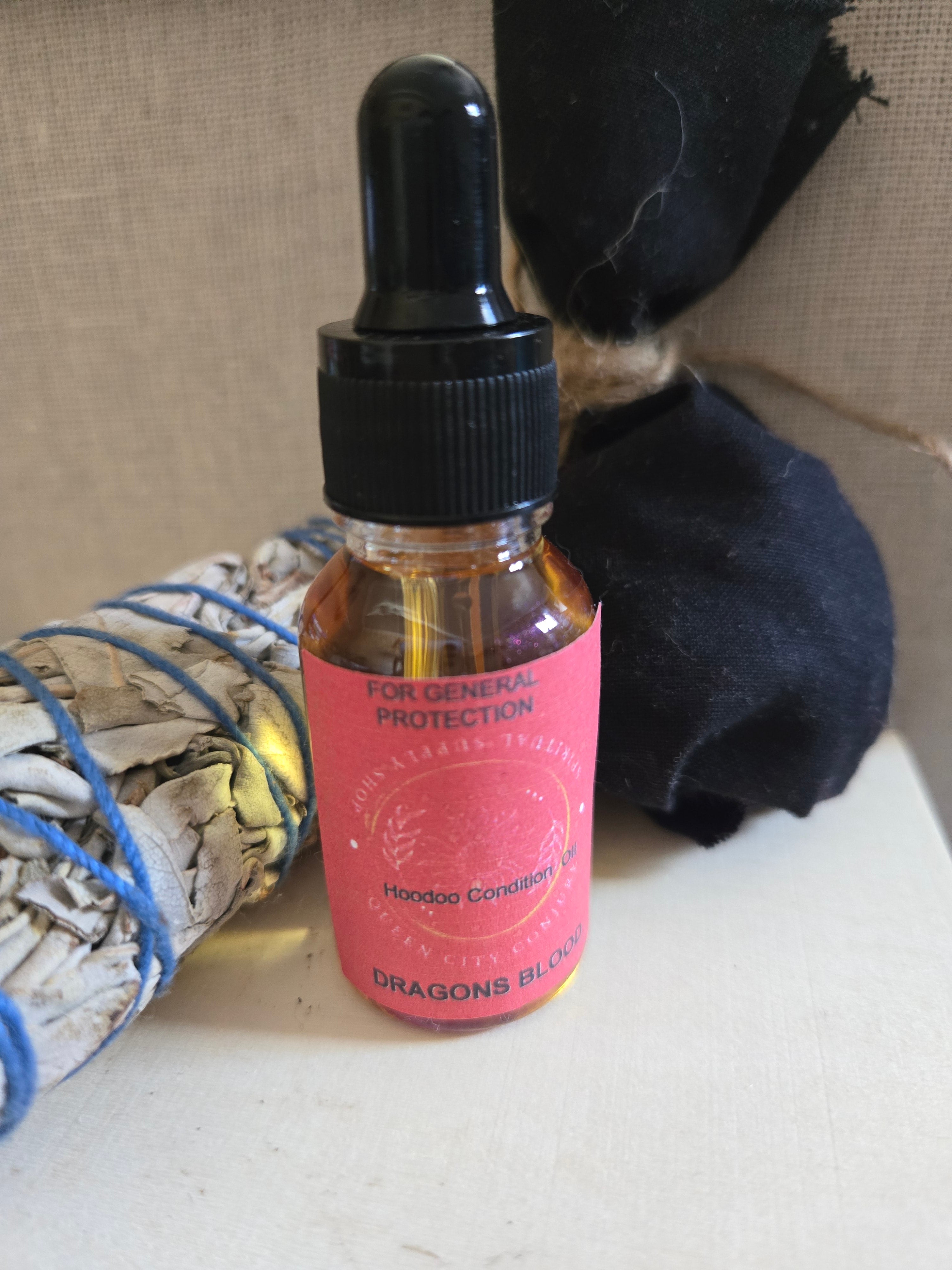 Protection Bundle includes Dragon Blood Protection Oil, Fiery Wall of Protection Oil, sage stick, Protection Mojo Bag and Railroad Spike