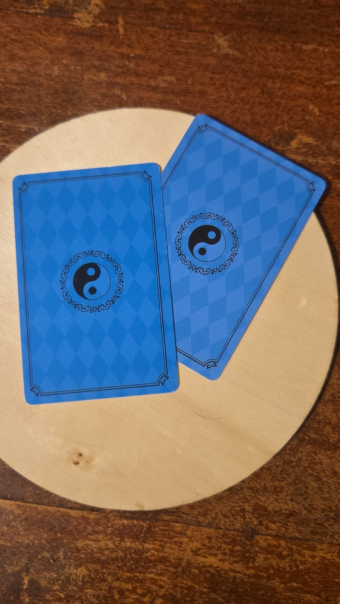 Two blue cards with a yin yang symbol 