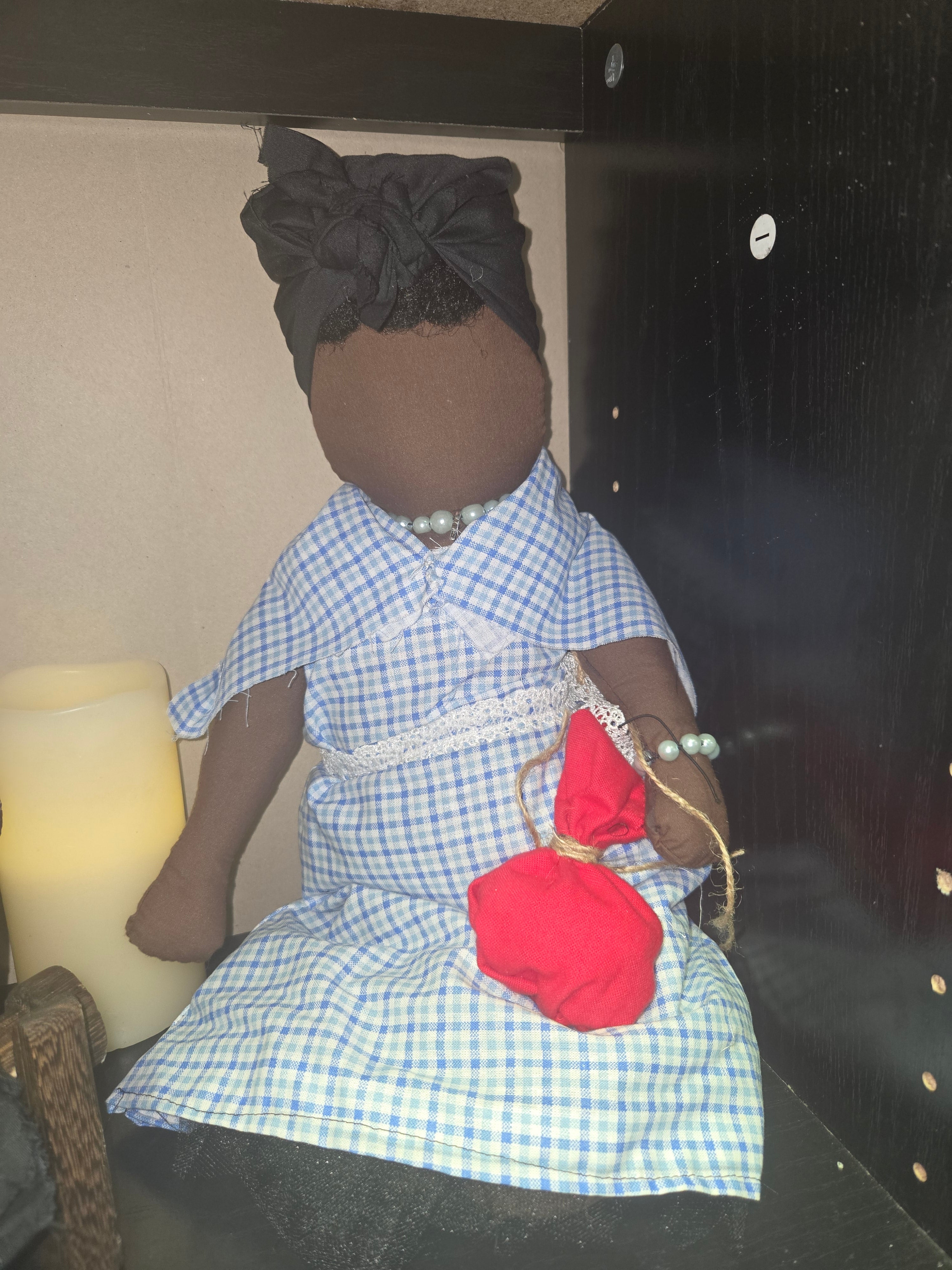 Big Mama ancestor doll  representing someone who needs support, focusing on their well-being.